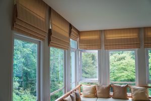 indoor view of windows with beige window coverings 