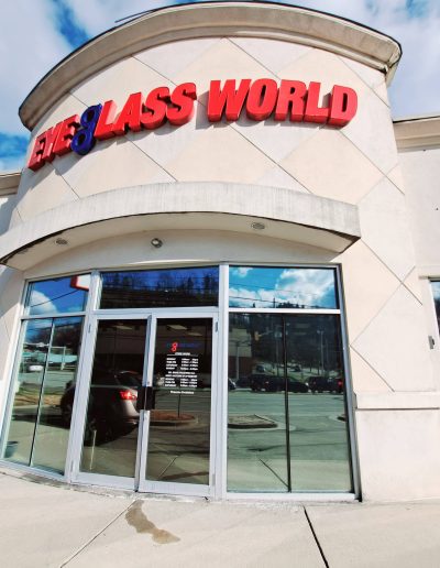 Front view of exterior of Eyeglass World retail store with glass doors and windows